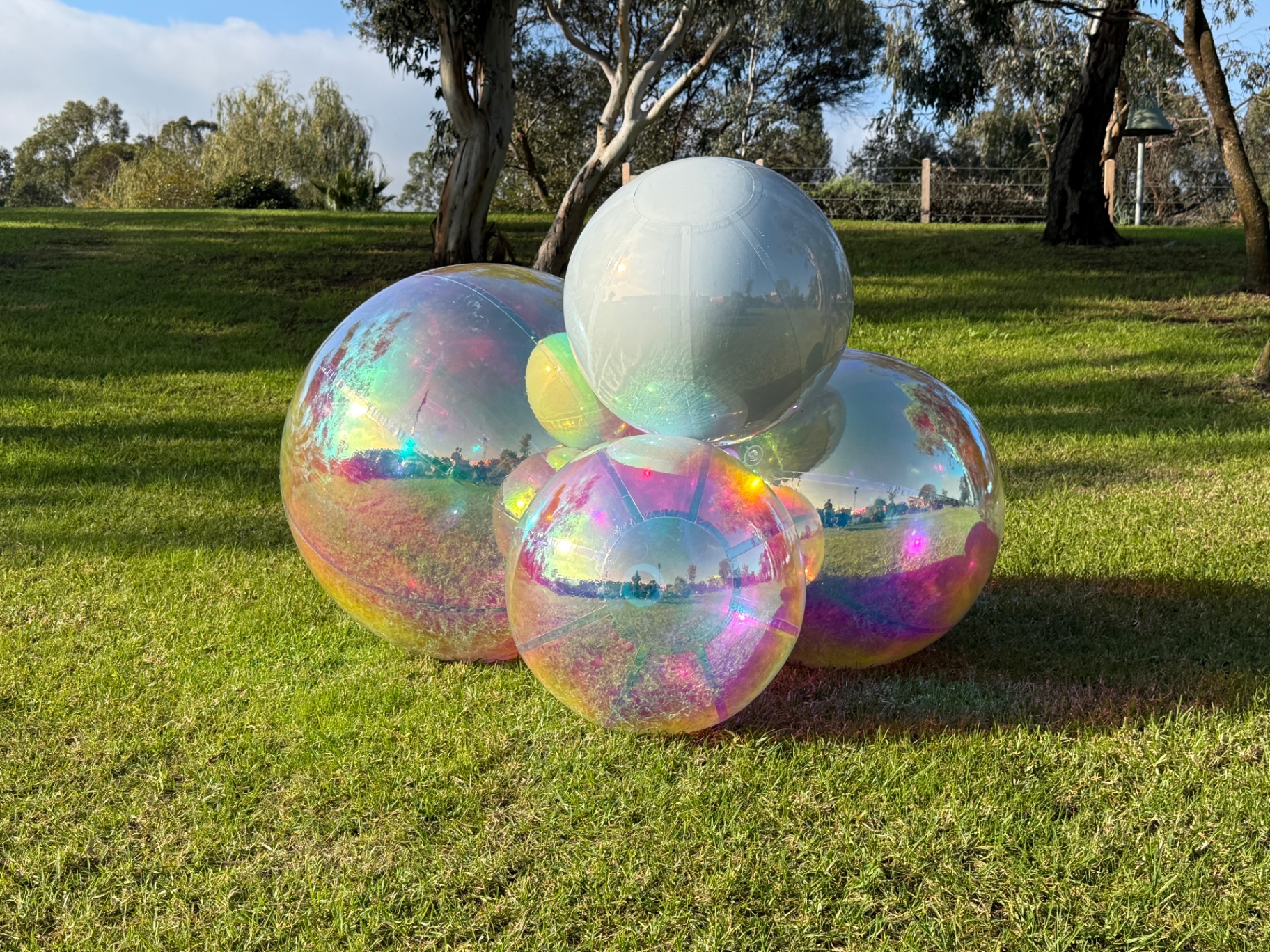 Iridescent spheres on a lawn at a private event
